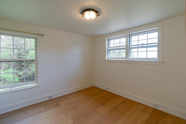 unfurnished room with light hardwood / wood-style flooring