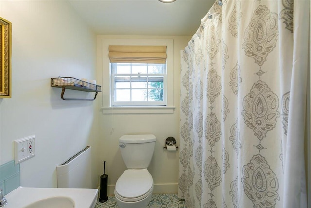 bathroom featuring sink, toilet, and tile patterned floors