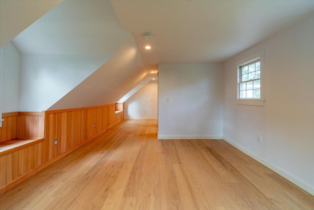 bonus room with light hardwood / wood-style flooring and vaulted ceiling