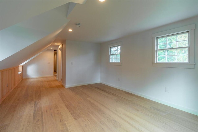 bonus room featuring light hardwood / wood-style flooring and lofted ceiling