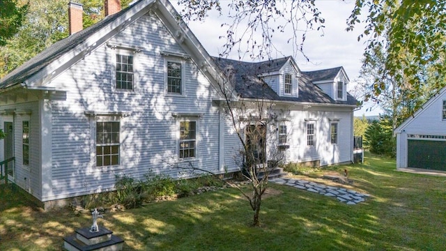 rear view of house featuring a lawn