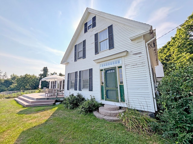 back of house with a yard and a deck