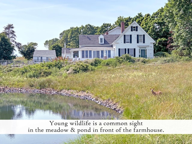 view of front facade with a water view