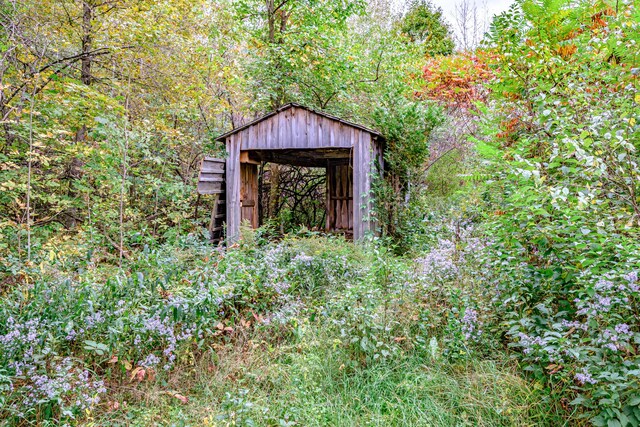 2457 Main St, Hanover, ME 04237 - view of shed with a forest view