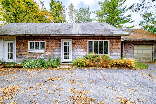 2457 Main St, Hanover, ME 04237 - back of house with an attached garage and a chimney