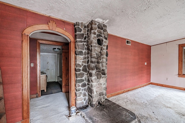 2457 Main St, Hanover, ME 04237 - carpeted empty room with arched walkways and a textured ceiling