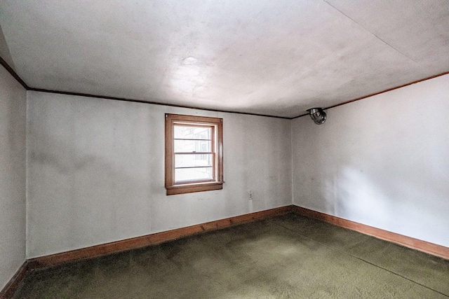 carpeted spare room with lofted ceiling