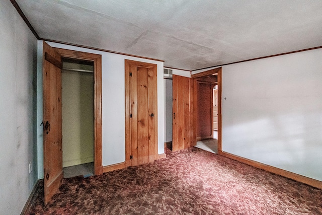 unfurnished bedroom with carpet floors and a textured ceiling