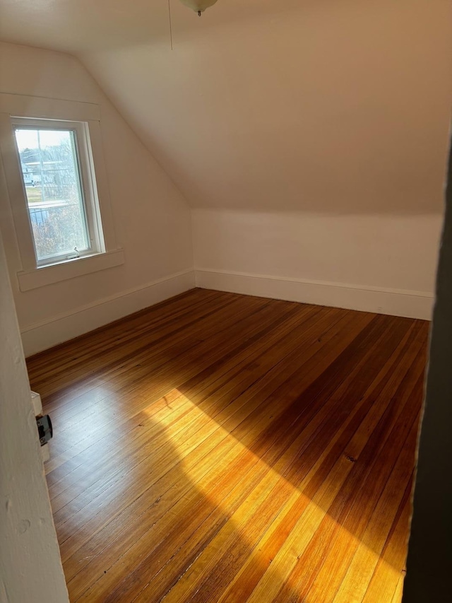 bonus room featuring wood-type flooring and lofted ceiling