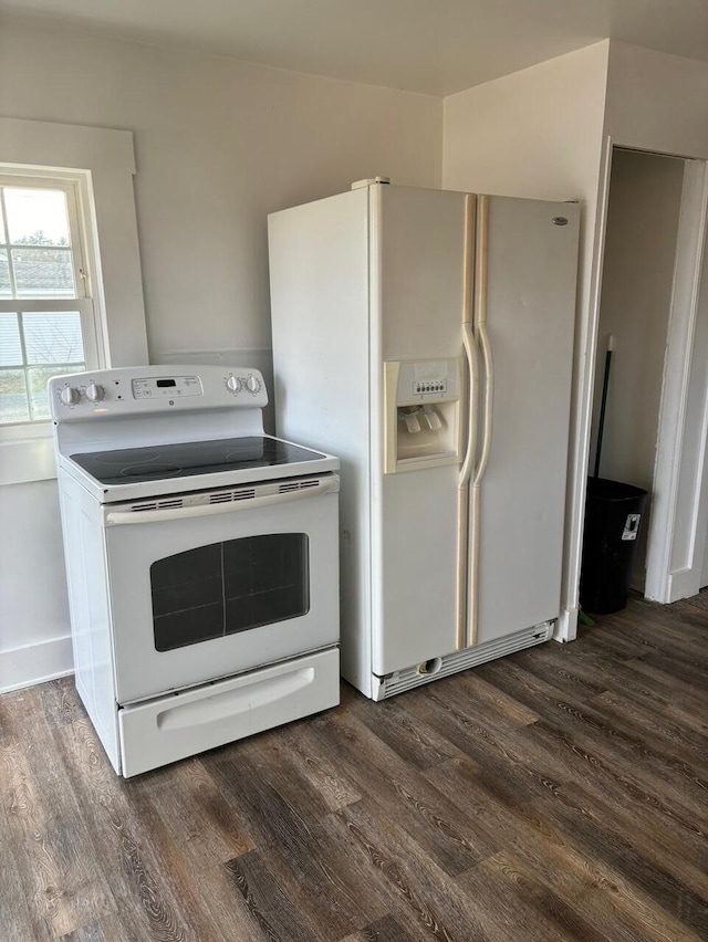 kitchen with white cabinetry, dark wood-type flooring, and white appliances