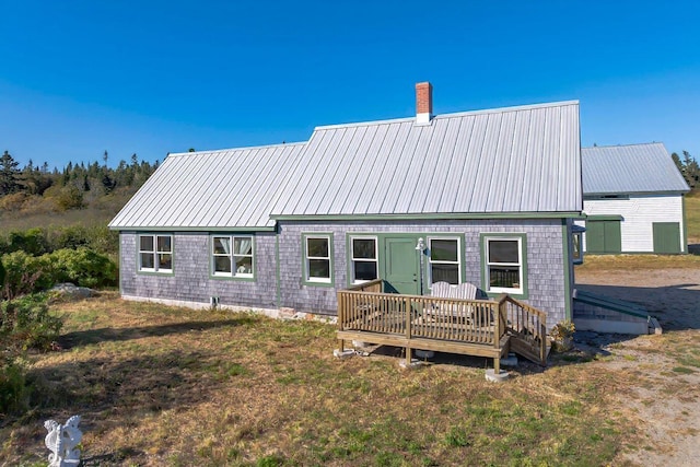 back of house featuring a wooden deck and a yard