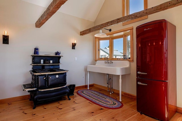 misc room featuring high vaulted ceiling, light hardwood / wood-style floors, and beamed ceiling