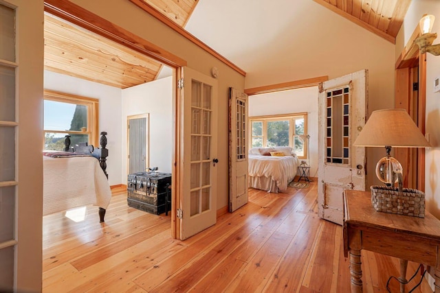 corridor featuring wood ceiling, vaulted ceiling, and light hardwood / wood-style flooring