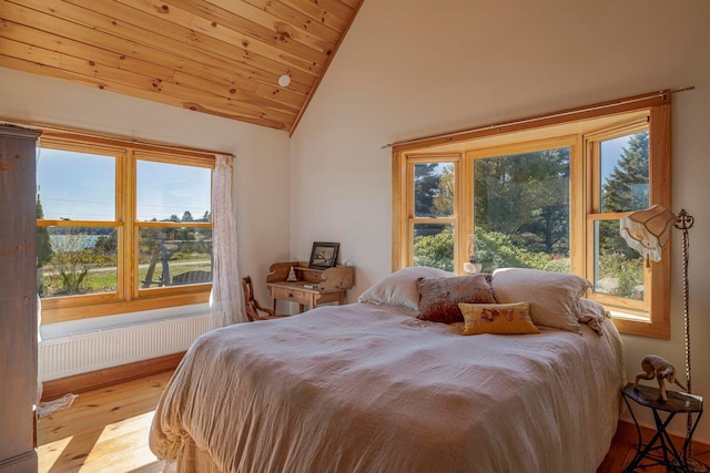 bedroom featuring vaulted ceiling, wood ceiling, light hardwood / wood-style floors, and multiple windows