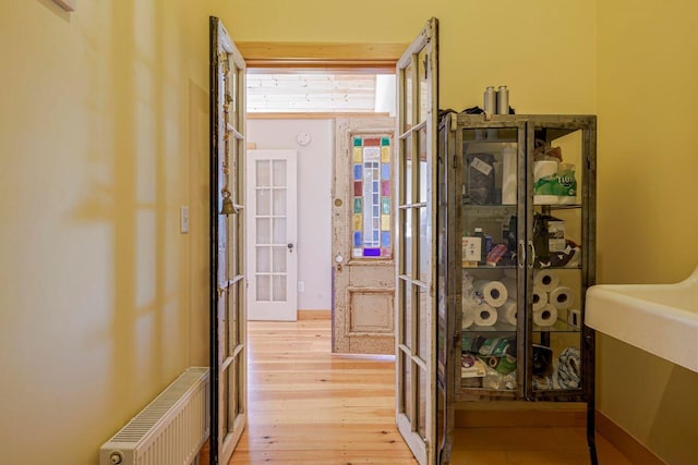 bathroom with wood-type flooring and radiator heating unit