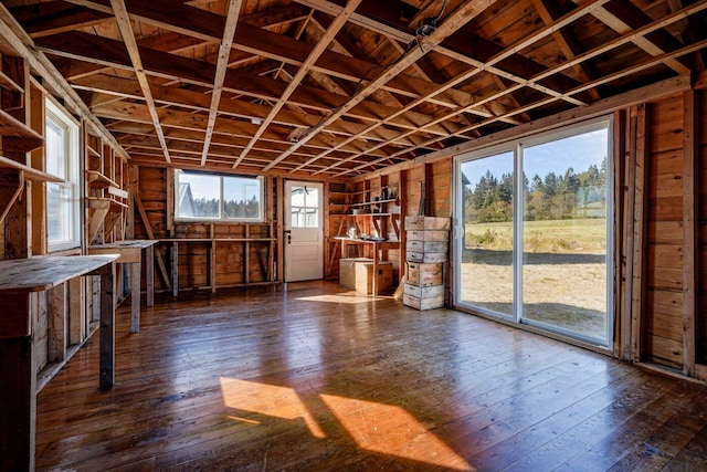 misc room featuring wood walls and dark wood-type flooring