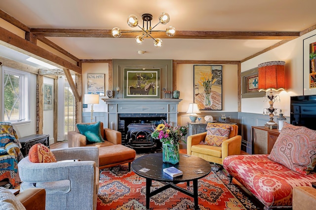 87 Carter Point Rd, Sedgwick, ME 04676 - living area featuring beam ceiling, a chandelier, a decorative wall, and wainscoting