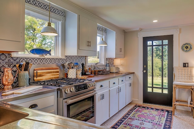 87 Carter Point Rd, Sedgwick, ME 04676 - kitchen featuring stainless steel gas range oven, white cabinets, healthy amount of natural light, ornamental molding, and recessed lighting