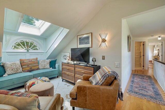 87 Carter Point Rd, Sedgwick, ME 04676 - living room with a skylight, light wood finished floors, and vaulted ceiling