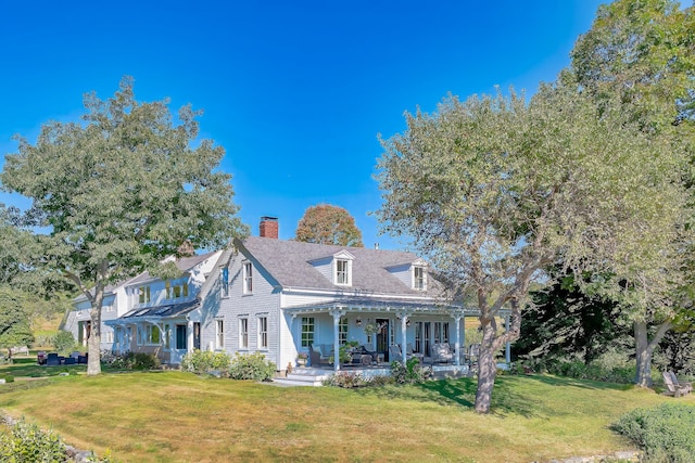 87 Carter Point Rd, Sedgwick, ME 04676 - view of front of property with a front yard, covered porch, and a chimney