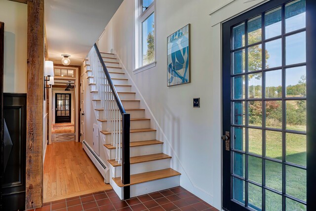 87 Carter Point Rd, Sedgwick, ME 04676 - stairs with baseboard heating, plenty of natural light, tile patterned floors, and baseboards