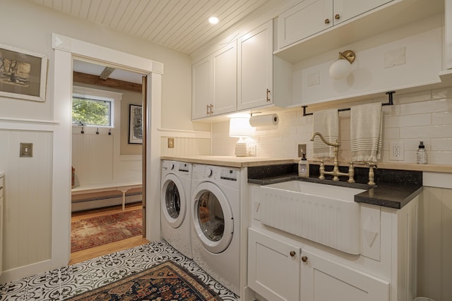 87 Carter Point Rd, Sedgwick, ME 04676 - laundry room featuring independent washer and dryer, a baseboard radiator, cabinet space, light wood-style flooring, and a wainscoted wall