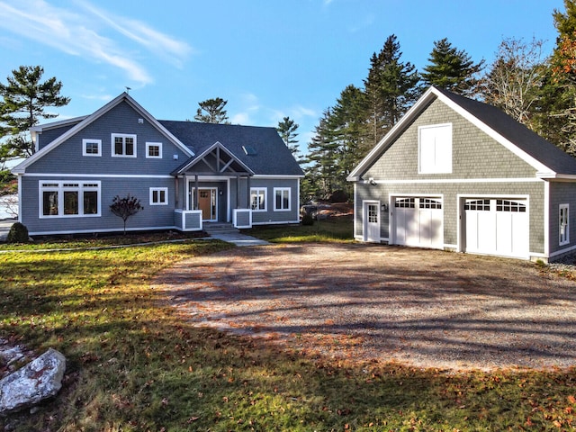 view of front of property with a garage, central air condition unit, and a front lawn