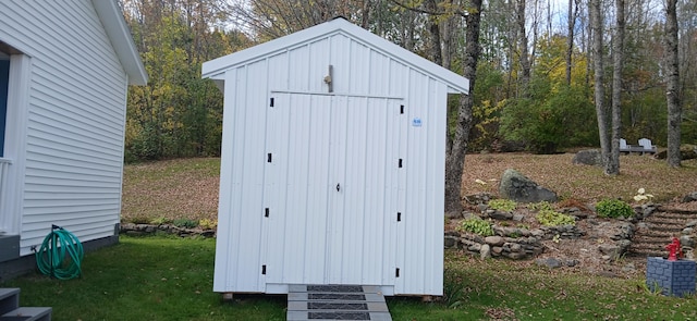 view of outbuilding featuring a lawn