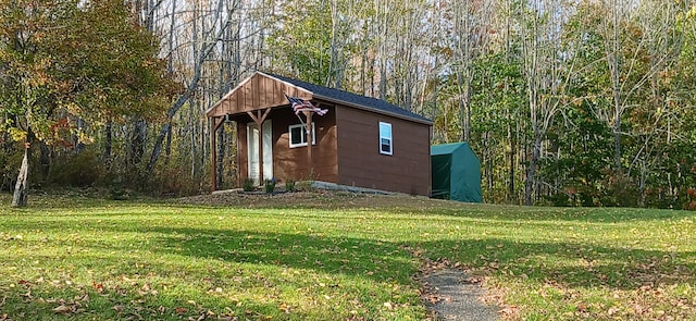 view of outbuilding with a lawn