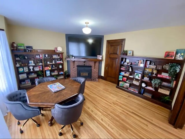 office with a fireplace and hardwood / wood-style flooring