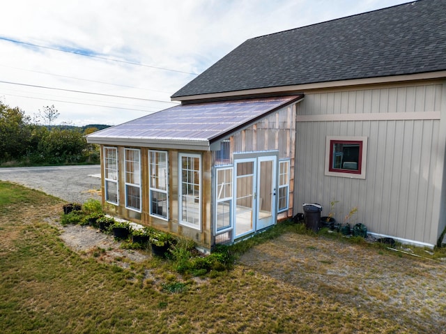 rear view of property with a sunroom