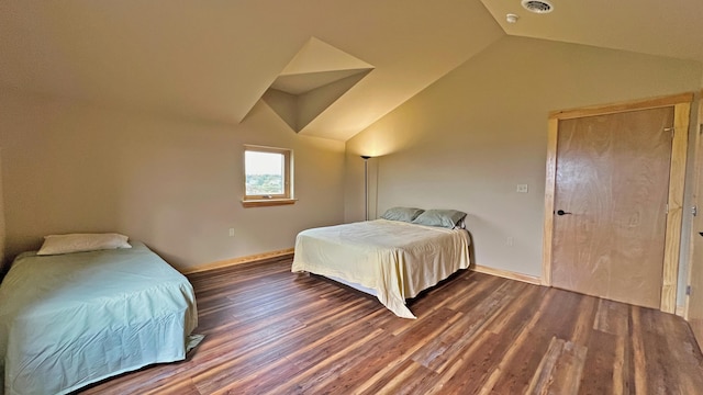 bedroom with vaulted ceiling and dark hardwood / wood-style flooring