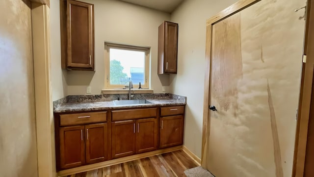 kitchen with sink and light hardwood / wood-style floors