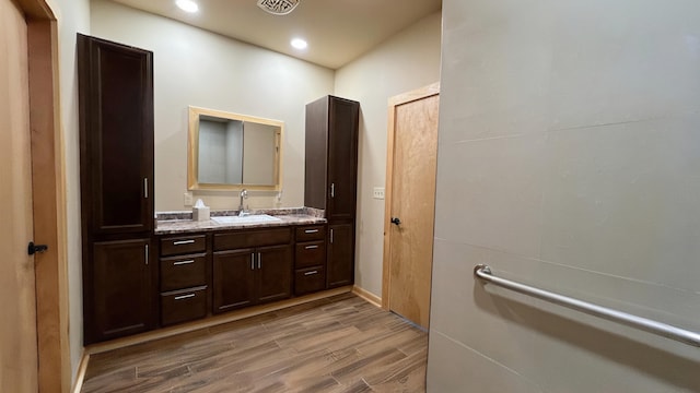 bathroom featuring hardwood / wood-style flooring and vanity