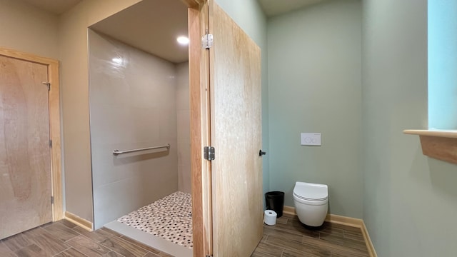 bathroom featuring walk in shower and toilet