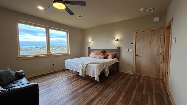 bedroom with ceiling fan and dark hardwood / wood-style floors