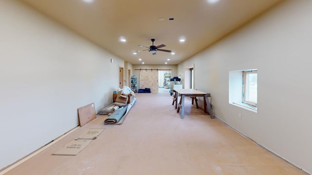 interior space with ceiling fan