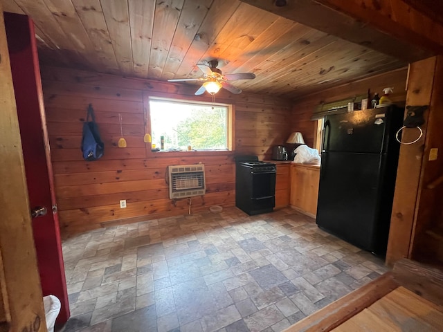 kitchen with wood ceiling, heating unit, black appliances, and wood walls