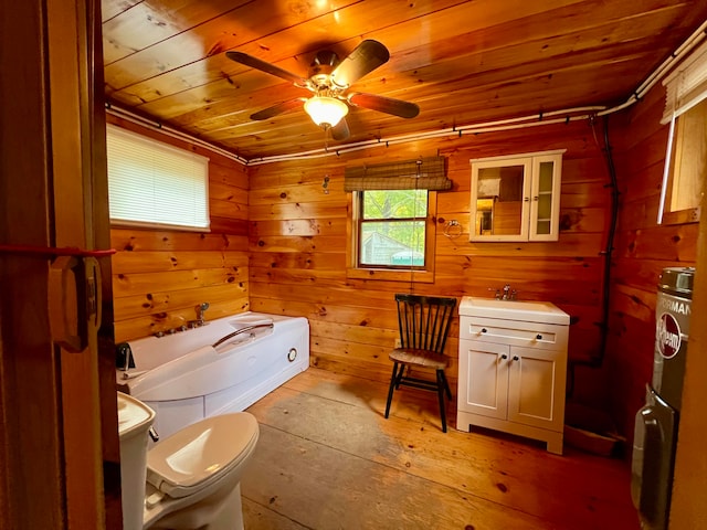 bathroom featuring wood ceiling, a tub to relax in, wood walls, and toilet