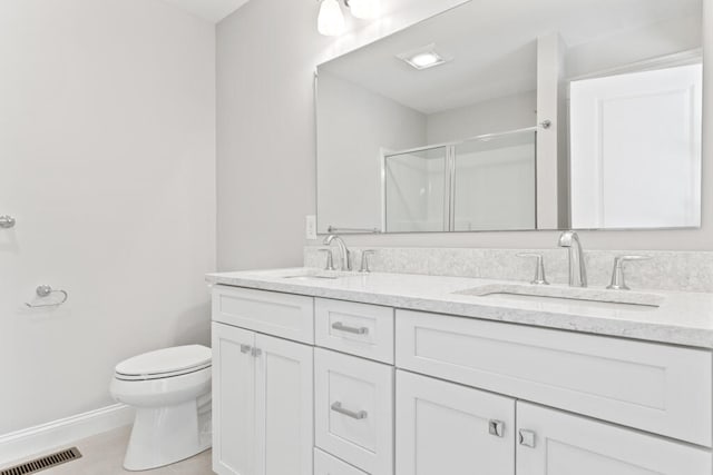 bathroom with walk in shower, vanity, and toilet