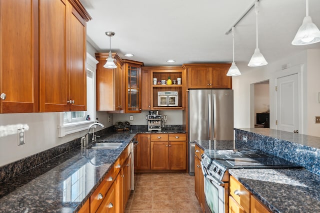 kitchen with stainless steel appliances, hanging light fixtures, and track lighting