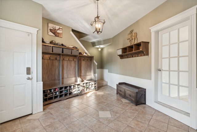 mudroom featuring an inviting chandelier and light tile patterned floors