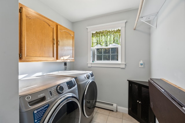 washroom featuring light tile patterned flooring, washing machine and clothes dryer, cabinets, and baseboard heating