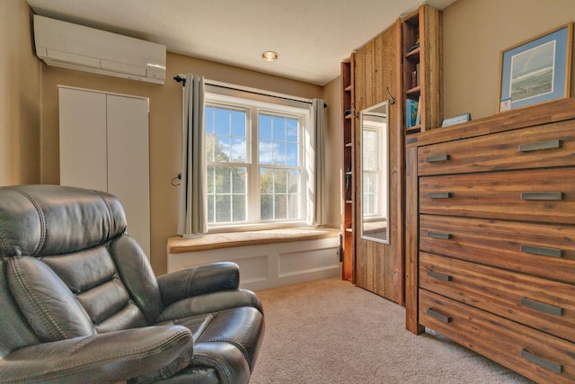 sitting room with light carpet and a wall mounted AC