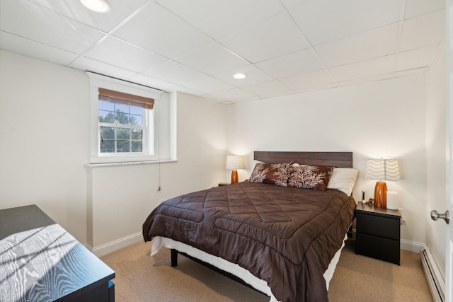 carpeted bedroom with a baseboard heating unit