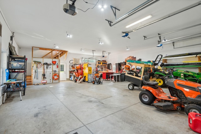 garage featuring a garage door opener and a workshop area