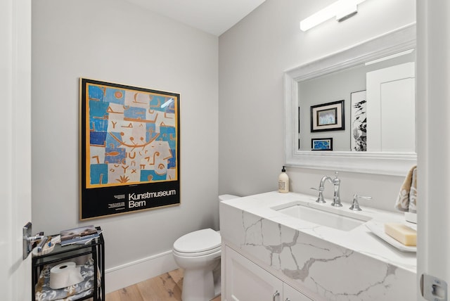 bathroom featuring hardwood / wood-style floors, vanity, and toilet