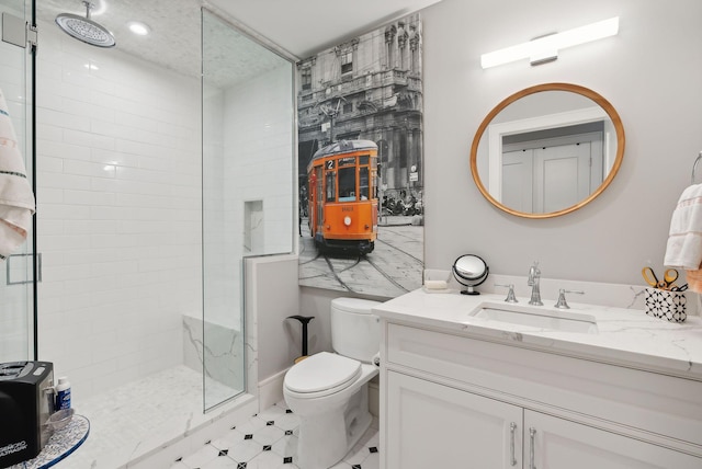 bathroom featuring vanity, an enclosed shower, and toilet