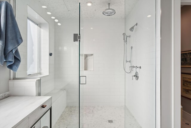 bathroom featuring a shower with door