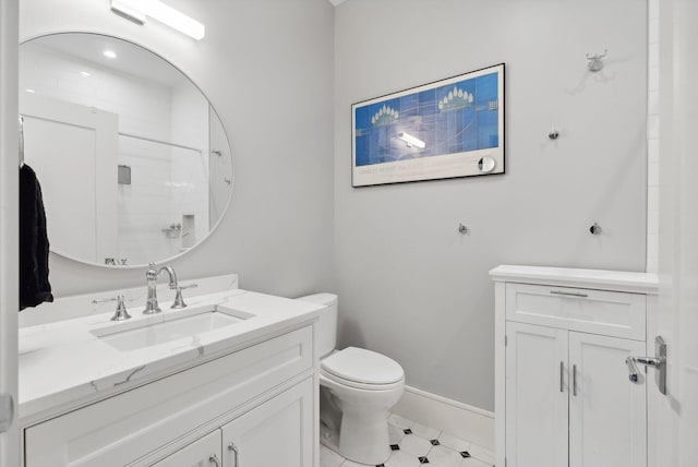 bathroom featuring vanity, toilet, and walk in shower